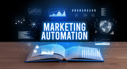 MARKETING AUTOMATION inscription coming out from an open book, creative business concept