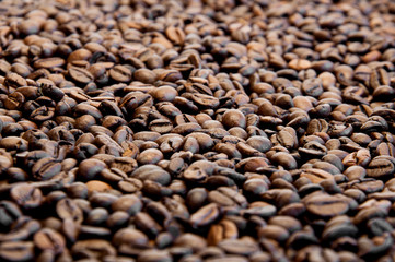 Whole bean coffee. Sprinkled fried. Close-up.