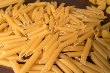 scattering Italian pasta penne, feathers