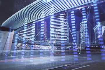 Forex chart on cityscape with tall buildings background multi exposure. Financial research concept.