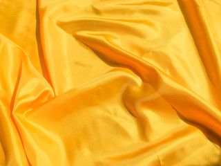 Beautiful yellow silk or satin texture background with copy space for design and artwork