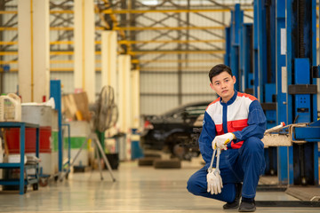 Obraz premium Mechanic,car service, repair, maintenance and people,Concept mechanic wrench at workshop.
