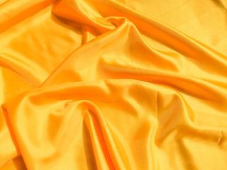 Fototapeta premium Minimal yellow fabric texture background. smooth elegant wavy light with cpoy space