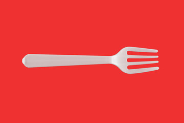 One plastic white fork on a red background. isolate. Top view.