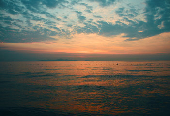 Fototapeta na wymiar Breathtaking seascape in Thailland in summer. Blue and pink sunset. Sandy beach is full of wildness and freshness. Suitable for poster template, leaflet, greeting card. Back lit. Touristic concepts.