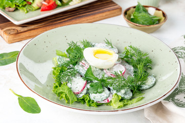 Salad with egg, radish, cucumber and fresh herbs