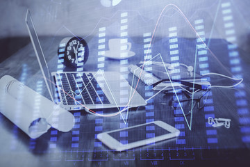 Stock market chart hologram drawn on personal computer background. Double exposure. Concept of investment.