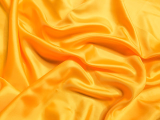 Yellow silk or satin texture background with copy space for design