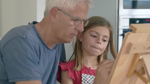 dad with daughter doing house painting