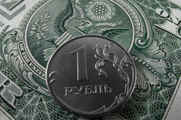 One ruble coin on a paper dollar. Top view.