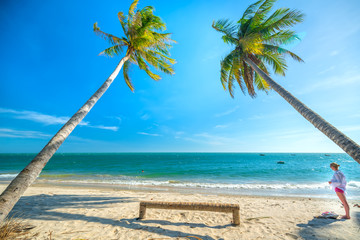 Foreign tourist is relaxing in a beautiful bay in the summer afternoon on a tropical beach in Mui Ne, Vietnam