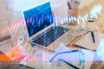 Financial chart drawing and table with computer on background. Multi exposure. Concept of international markets.