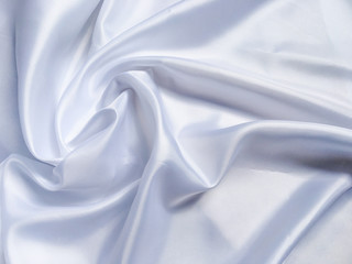 Obraz premium white crumpled fabric texture background. Silk curtain with fold waves for design