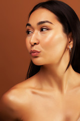Fototapeta premium young pretty asian woman cheerful smiling posing on warm brown background, lifestyle people concept