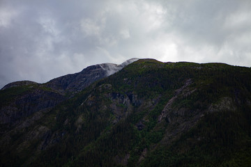 Fog in the Norwegian mountain forests. Dramatic Smoky Mountains