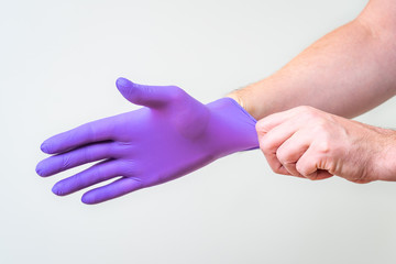 Male hand pulling a glove on