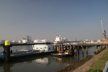 Fototapeta na wymiar Pier at the Pernis harbor to load fuel on inland ships in the Rotterdam Port The Netherlands