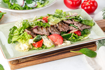 Salad of meat, tomato, cucumbers and fresh herbs