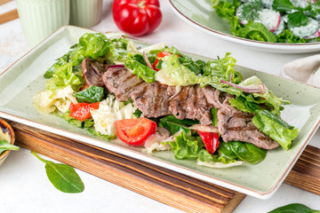Salad of meat, tomato, cucumbers and fresh herbs