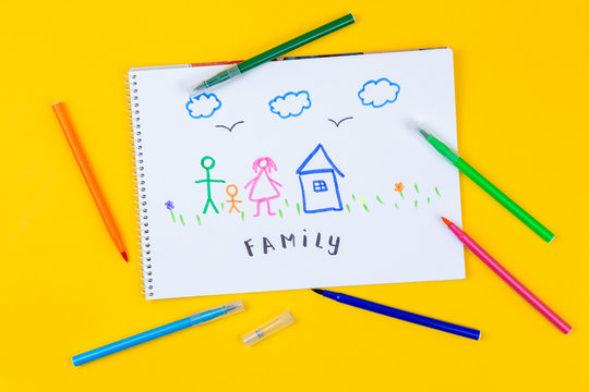 Home, love, family, still life concept. felt-tip pen lying on a paper with children's drawing family. Selective focus, copy space background