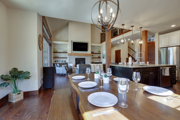 An absolute beautiful luxury living room with huge vaulted  ceiling, fire place, harwood floor, amazing furniture, and lots of windows and doors.