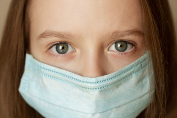 The girl wearing protection face mask against coronavirus. 