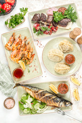 Meat kebab, fried fish with salad and shrimp with lemon