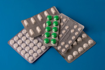 tablets, medicines in blister packs, isolated on a blue background