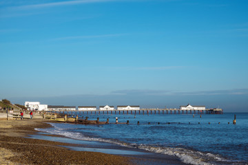 Blue sky and blue sea with a white pier at Southwold, Suffolk, England