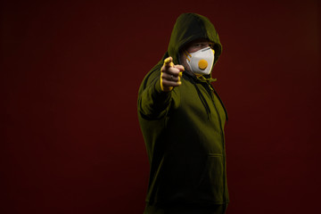 adult man with a beard in a hood and in a protective mask on his face with different emotions,...