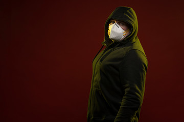 adult man with a beard in a hood and in a protective mask on his face with different emotions,...