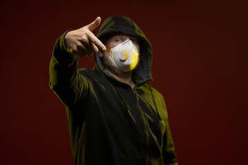adult man with a beard in a hood and in a protective mask on his face with different emotions,...
