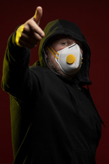 adult man with a beard in a hood and in a protective mask on his face with different emotions,...
