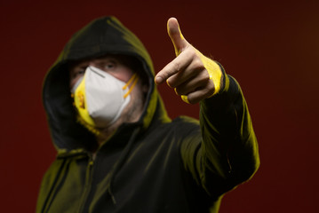 adult man with a beard in a hood and in a protective mask on his face with different emotions,...