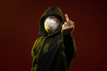 adult man with a beard in a hood and in a protective mask on his face with different emotions,...