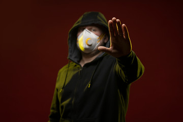 adult man with a beard in a hood and in a protective mask on his face with different emotions,...