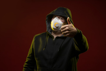 adult man with a beard in a hood and in a protective mask on his face with different emotions,...