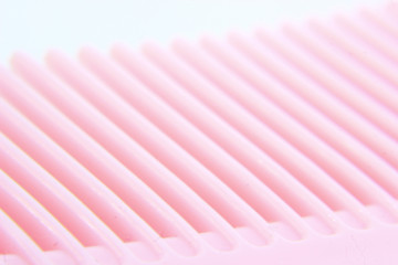 macro photo of pink hair comb
