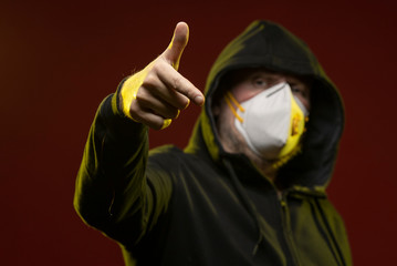 adult man with a beard in a hood and in a protective mask on his face with different emotions,...