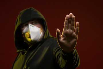 adult man with a beard in a hood and in a protective mask on his face with different emotions,...