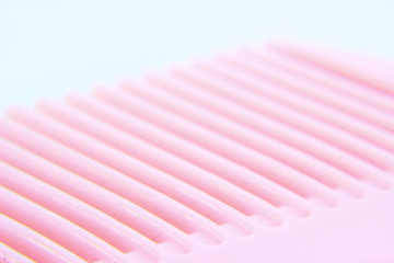 macro photo of pink hair comb