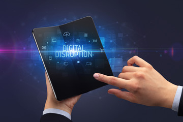 Businessman holding a foldable smartphone with DIGITAL DISRUPTION inscription, cyber security concept