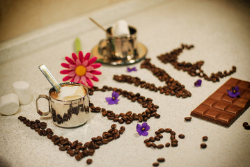Coffee for two with a chocolate bar and a beautifully decorated table. Declaration of love.