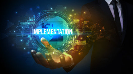 Naklejka premium Elegant hand holding IMPLEMENTATION inscription, digital technology concept