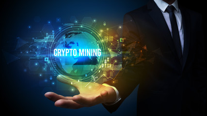 Elegant hand holding CRYPTO MINING inscription, digital technology concept