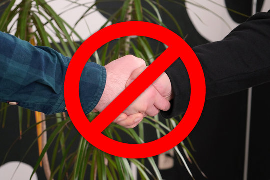No Handshakes greeting to avoid the spread of coronavirus. Covid-19 Changes Etiquette. No handshake stop sign on businesses background. Keeping distance. Hygiene and Quarantine Concept.