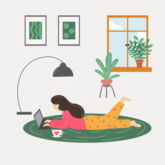 Fototapeta premium Girl lying on the floor and working on laptop at home.