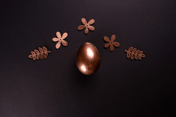 Easter minimal background with gold Easter eggs on black background. Flat lay, Top view, copy space.