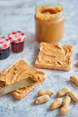 Two tasty peanut butter toasts placed on stone table
