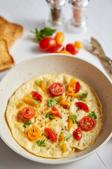 Tasty homemade classic omelet with cherry tomatoes